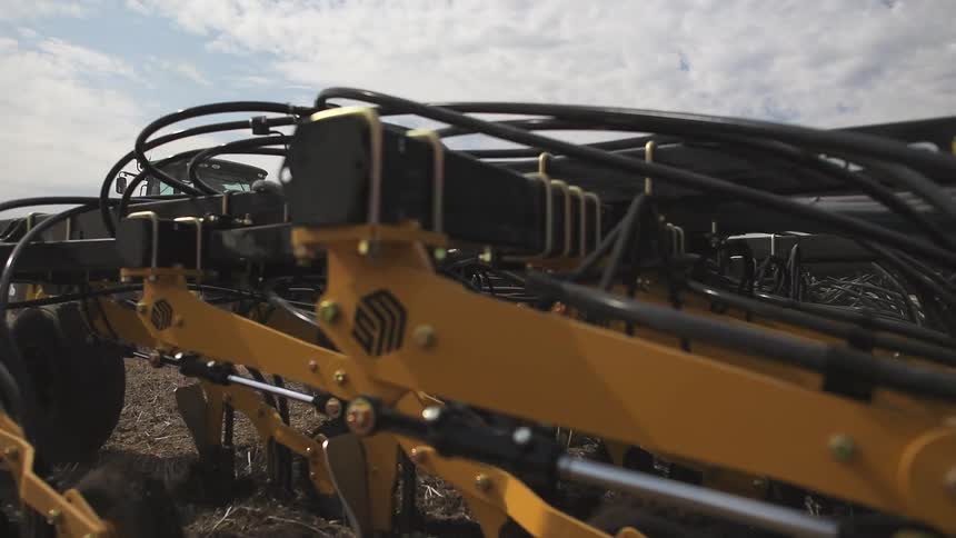 A farm vehicle is dragging up the dirt on the land