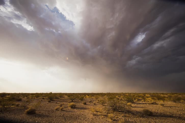 Clouds roll over a scrubby desert