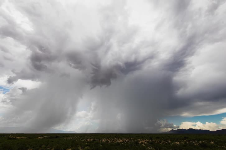 Rain falls from roiling clouds