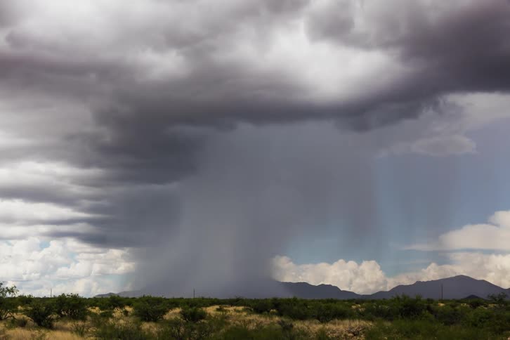A storm moves over distant mountains