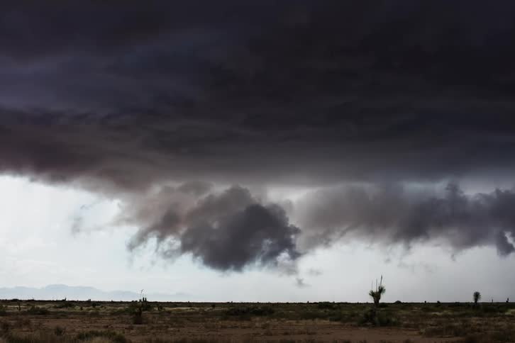 Storm clouds gather over plains