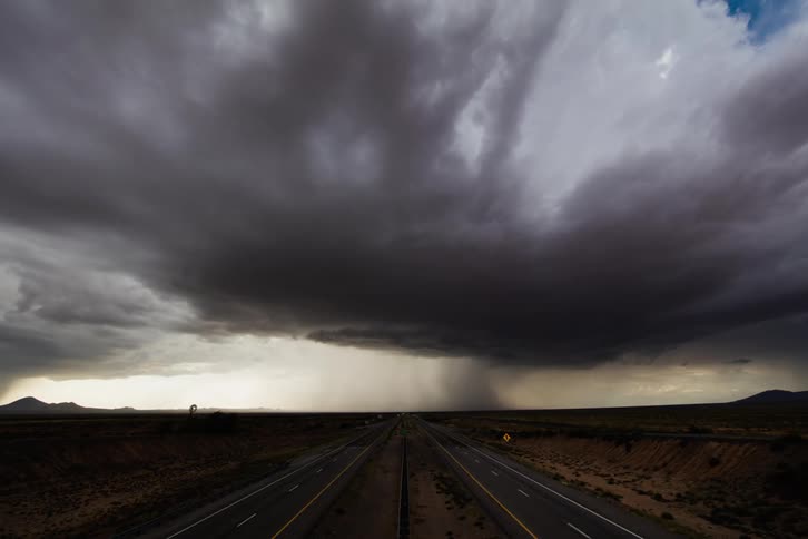 A storm crosses a road