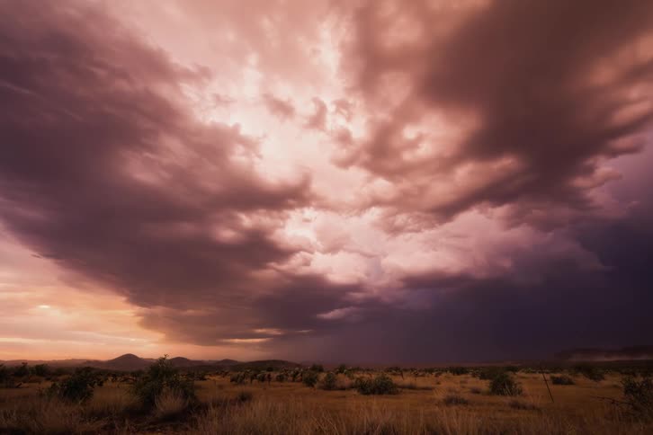 Clouds rolling over plains at sunset