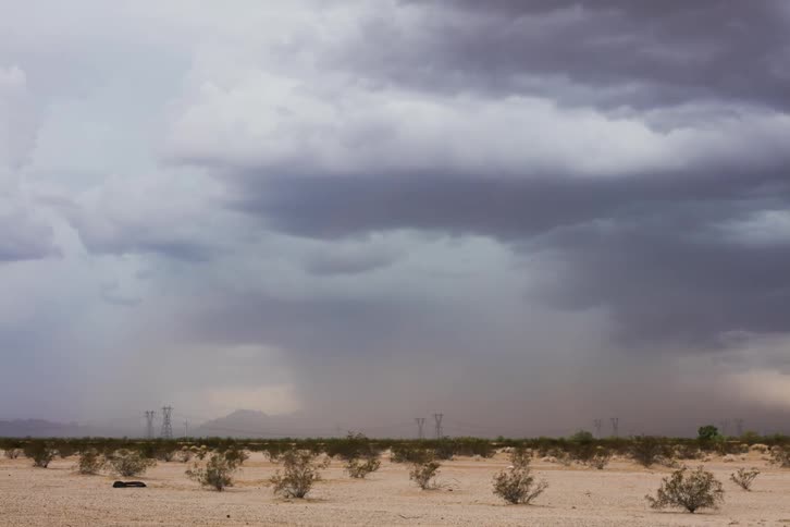 Clouds rolling over bushy plains