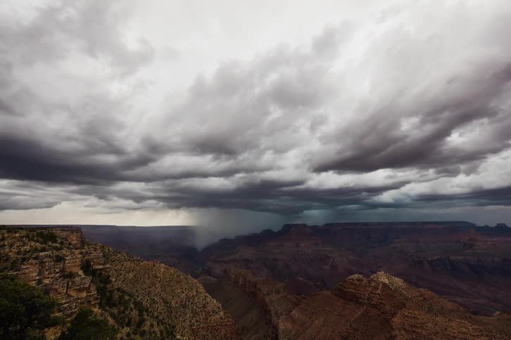 The rain clouds move fast over the mountains