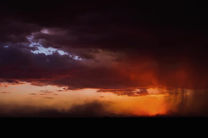 Sun shining through clouds on plains