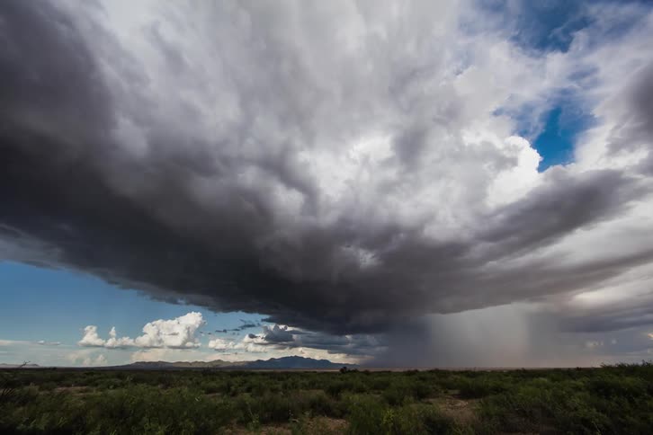 Clouds roll over a scrubby plain