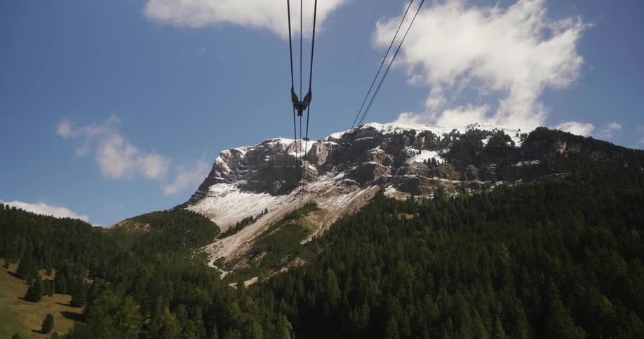 Cables over a forest lead to a mountain
