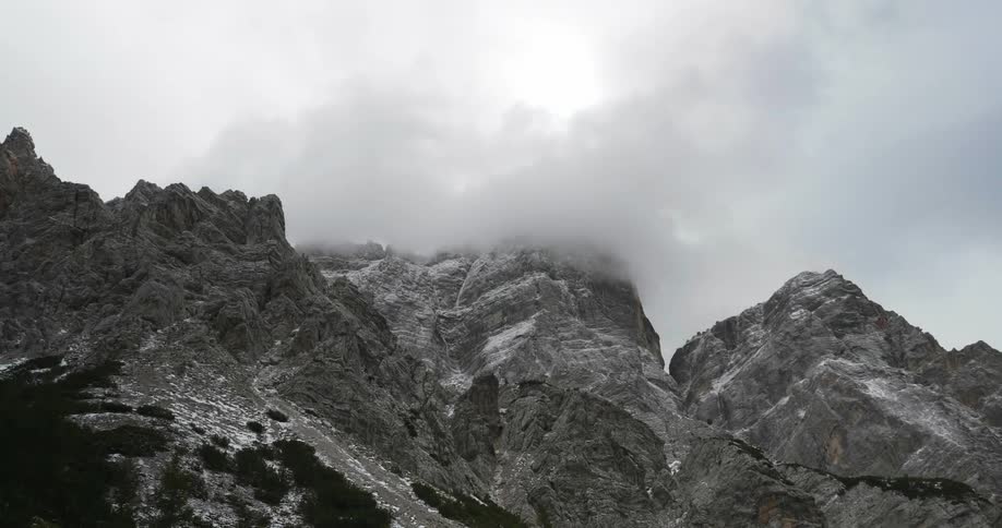 Clouds touching rocky mountain tops
