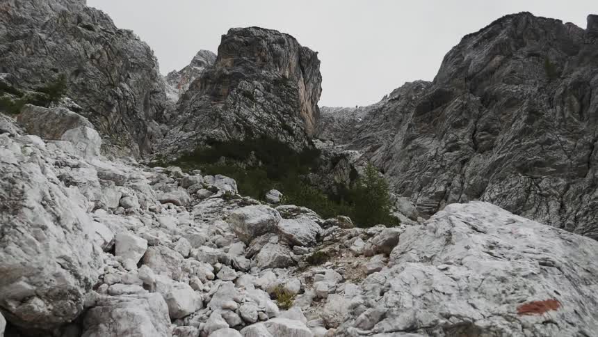 White stones are strewn across the side of a stone formation