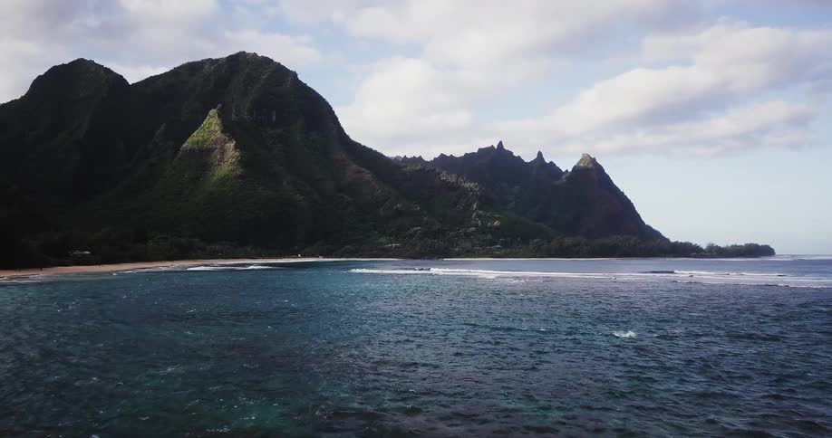 A large mountain surrounded by water
