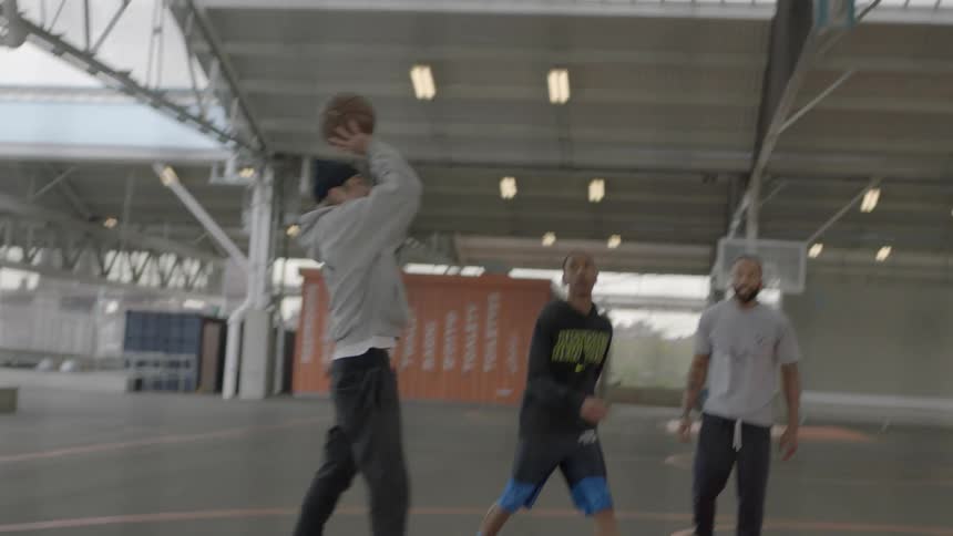 Men playing basketball in the city