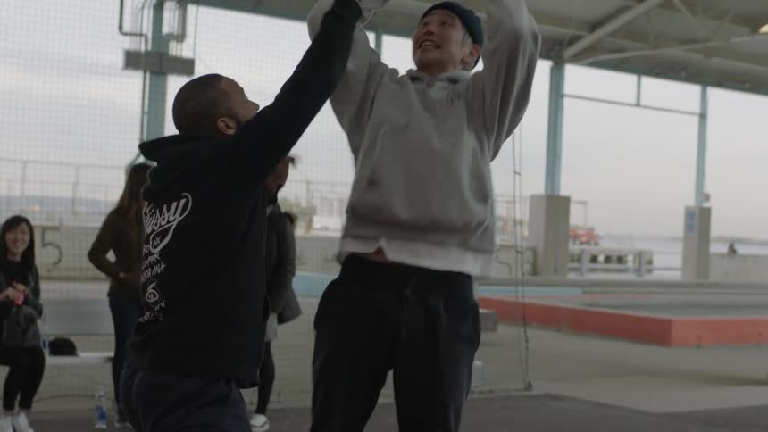 Group of men playing basketball in the city