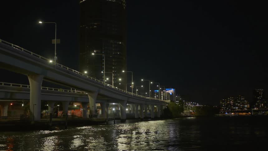 Bridge over a river in a city at night