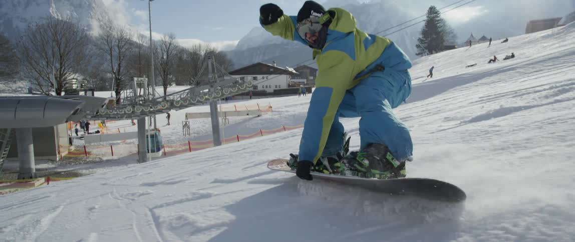 Person snowboarding down a steep slope