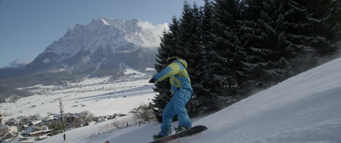 Snowboarder glides down the mountainside