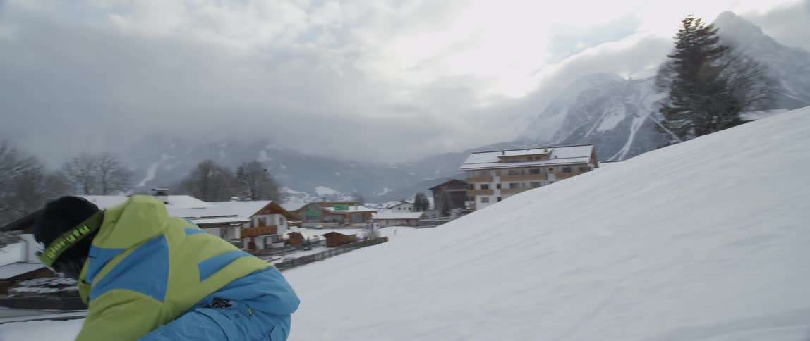 A man snowboards down a slope