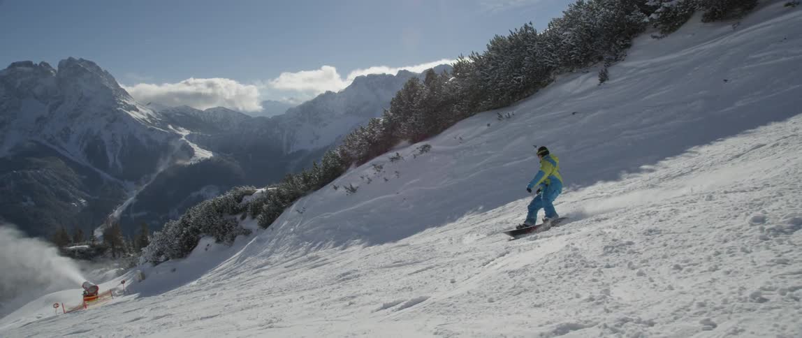 A person snowboards down a hill