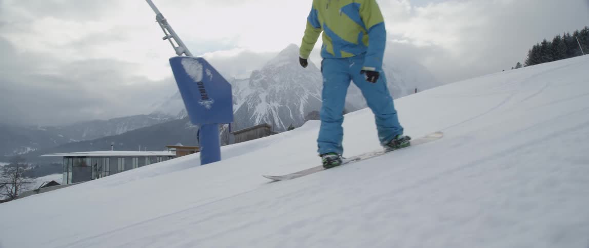 A man snowboards down a slope