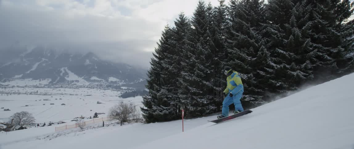 A person snowboards down a hill