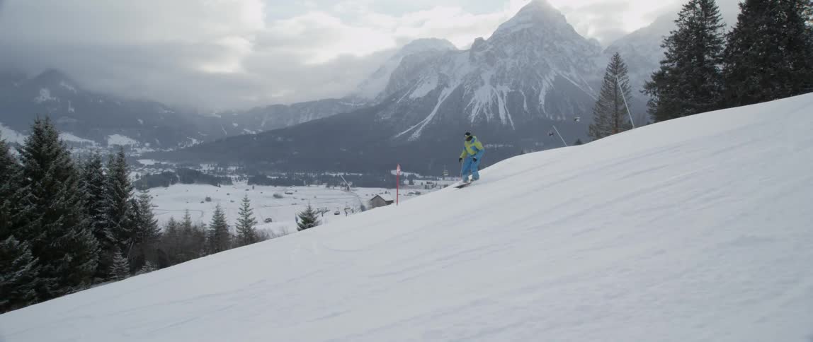 A man snowboards down a mountain