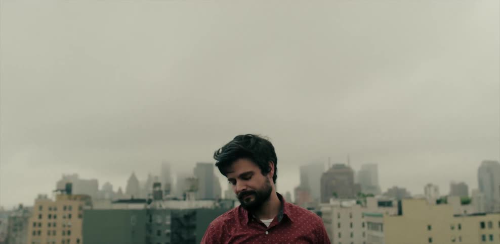 Man standing outside in a city on a cloudy day