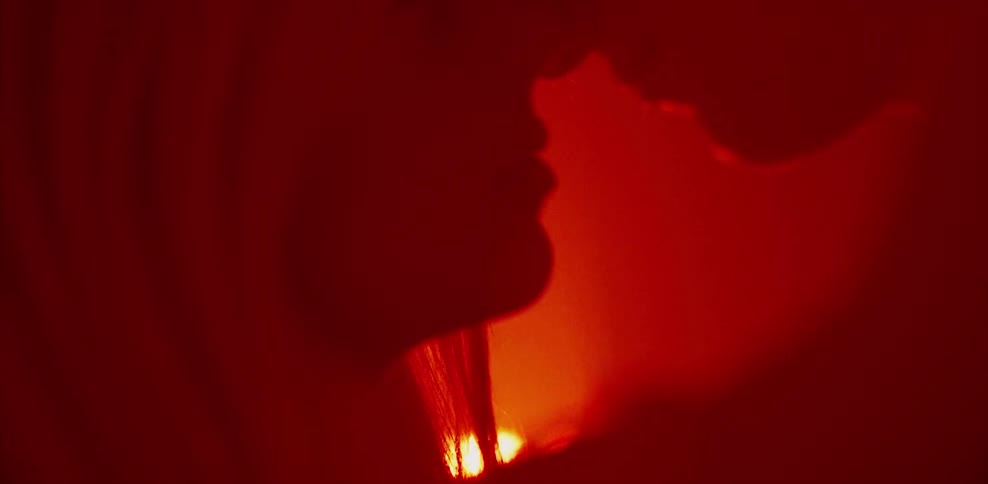 Man and woman making out in red light