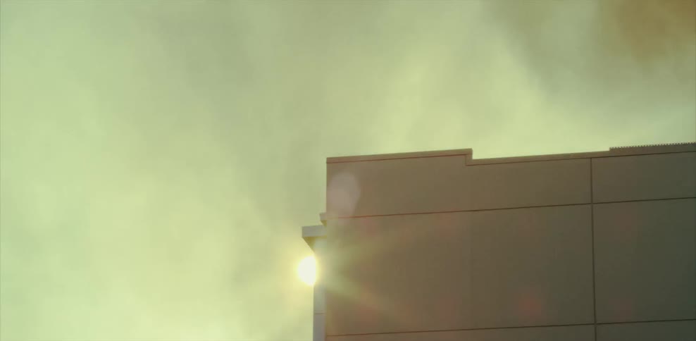 Smoke billows up from a building in a city