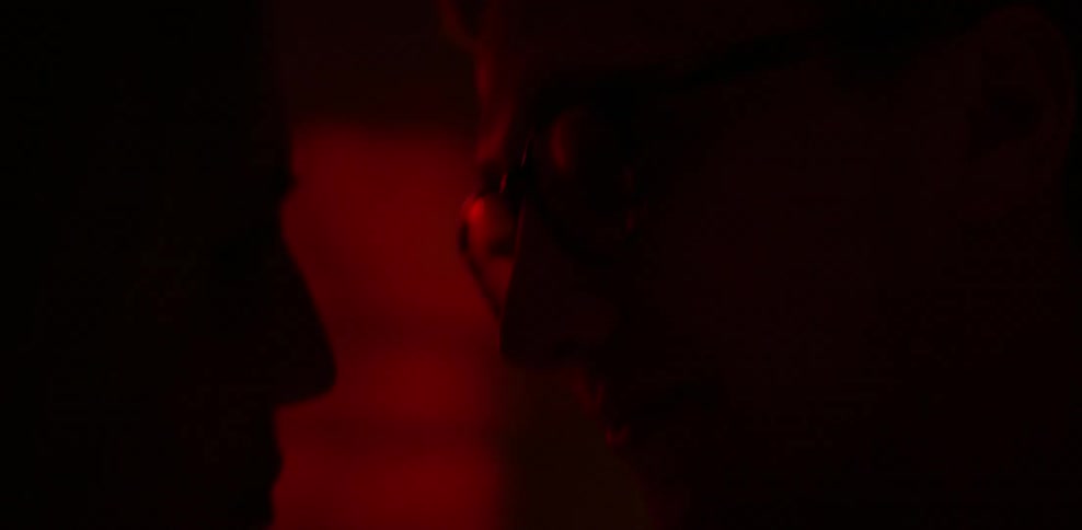 Two people are dancing in a dark room