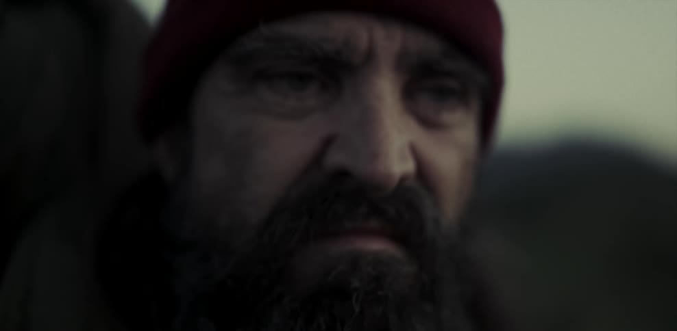 Frowning elderly man looks around outside