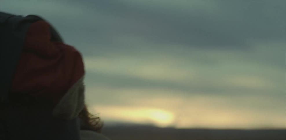 Bearded man walks outside at sunset