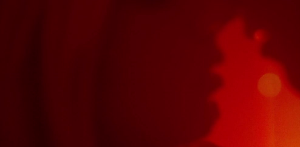 Man and woman hug and kiss in red light