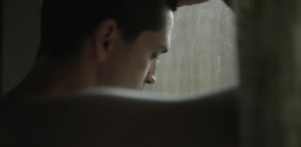 A man peers out a window