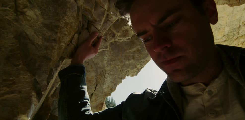 A man stands in a cavern