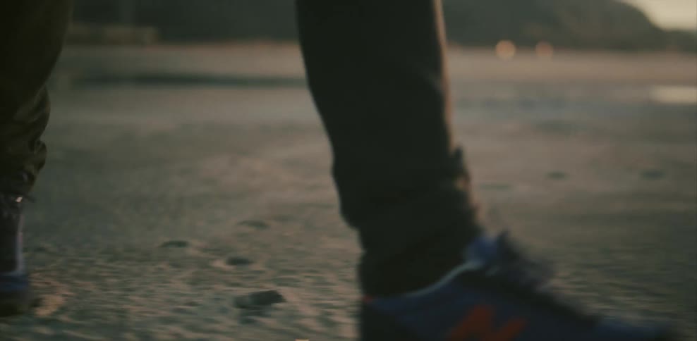 Person walking over sandy ground