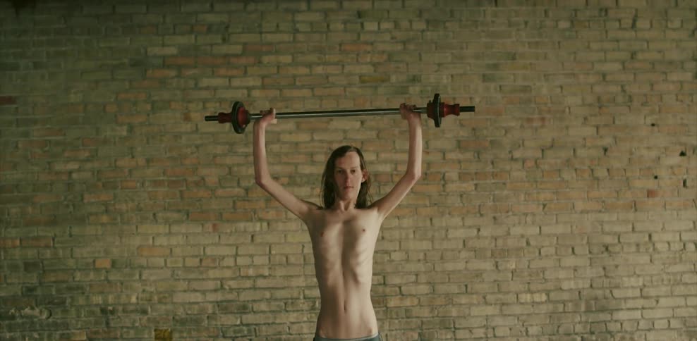 A man lifts a weight high above his head