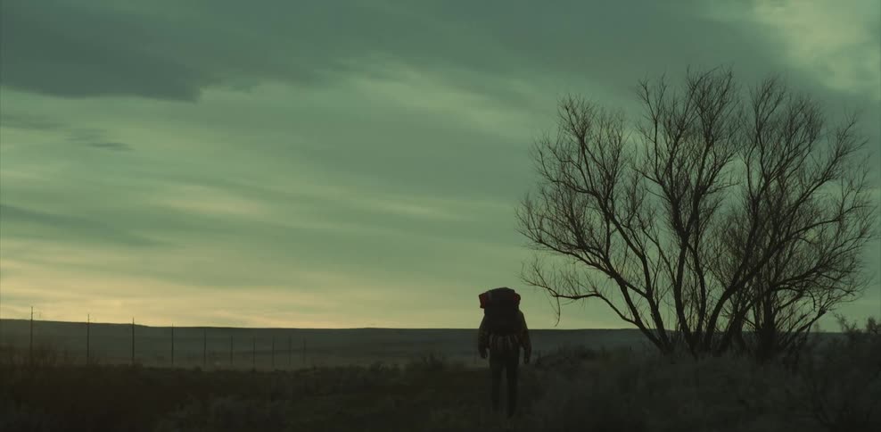 Person backpacking on a cloudy winter day
