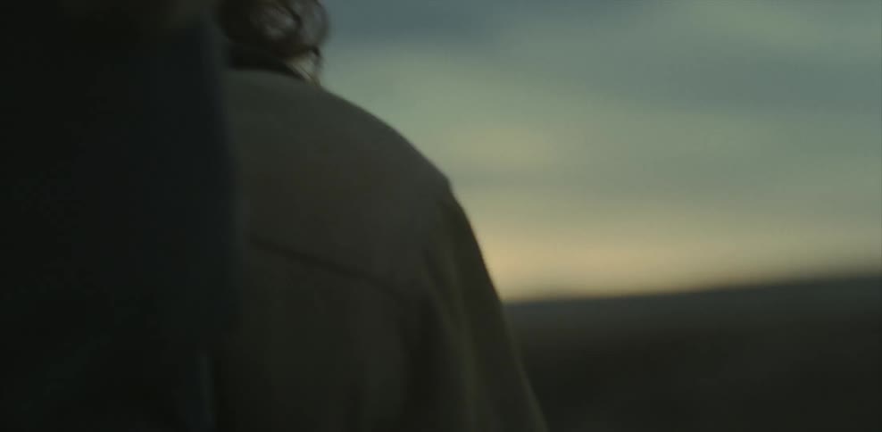 Man walks outside at sunset