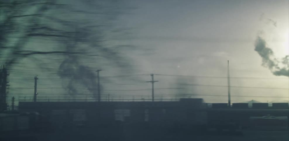 Smoke rises from the warehouses ahead