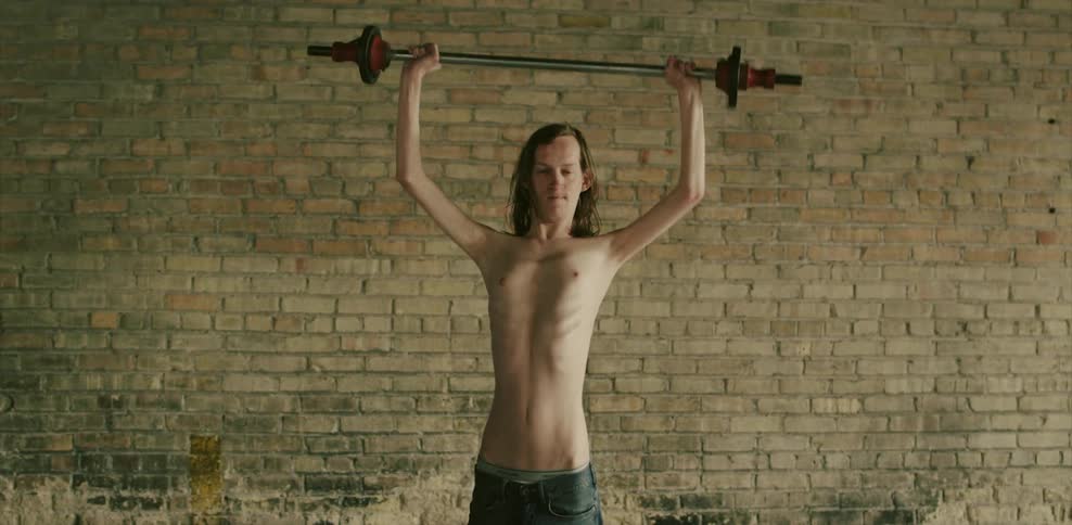 A man lifting a bar with weights above his head