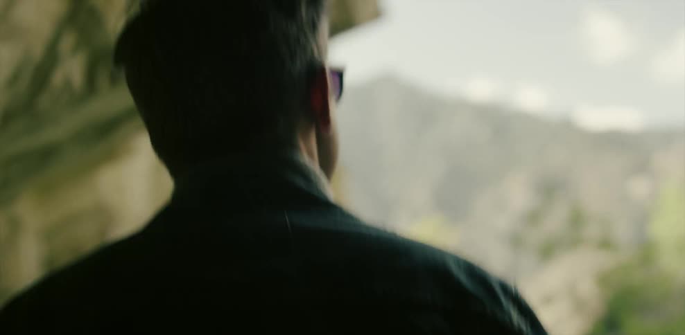 A man walks through a rock tunnel