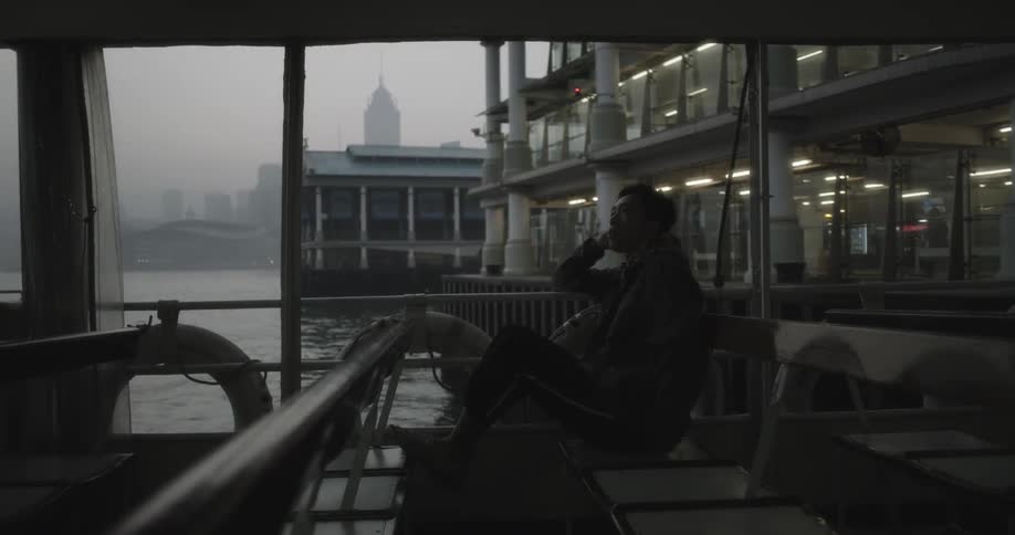 A person is riding a bus on a cloudy day