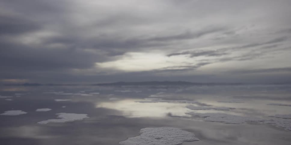 Ice floating on top of a lake on a cloudy day