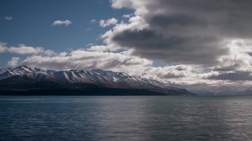 Clouds floating over a mountain lake
