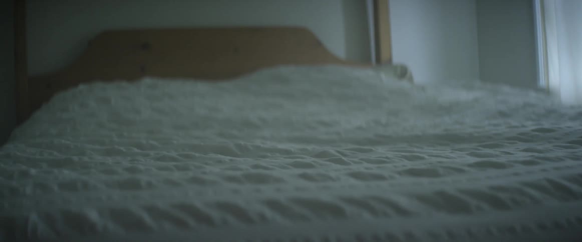 White blanket on a bed