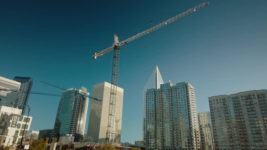 Crane towering against a cityscape