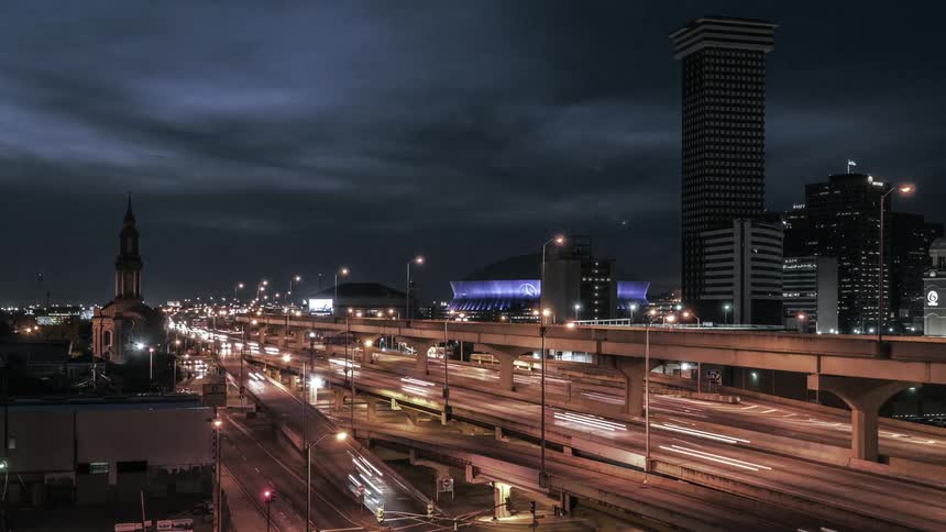 Timelapse of a night scene of cars speeding along a freeway