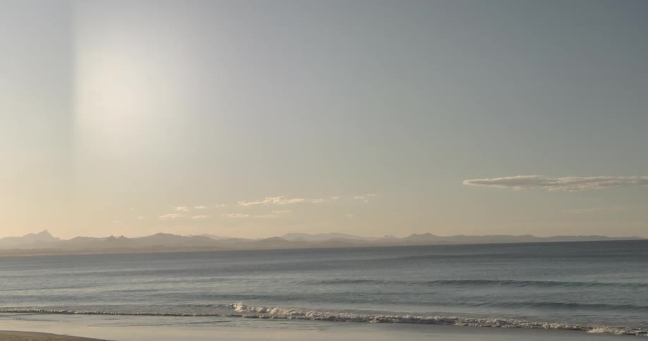Waves come to shore on a sunny day