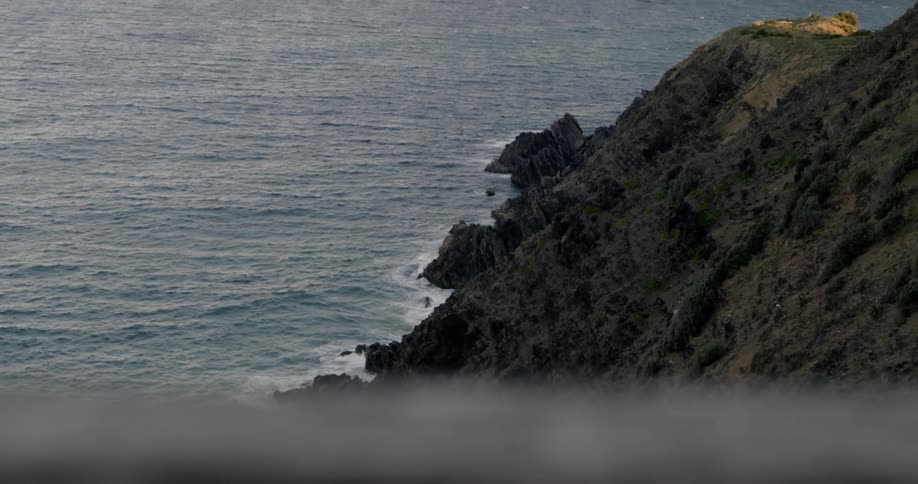 A rocky cliffside lines the coast