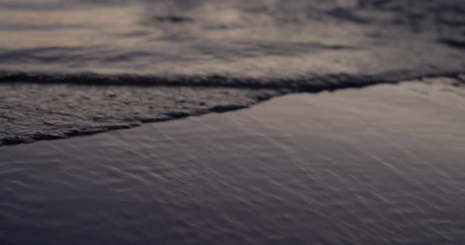 Waves slowly roll over the beach